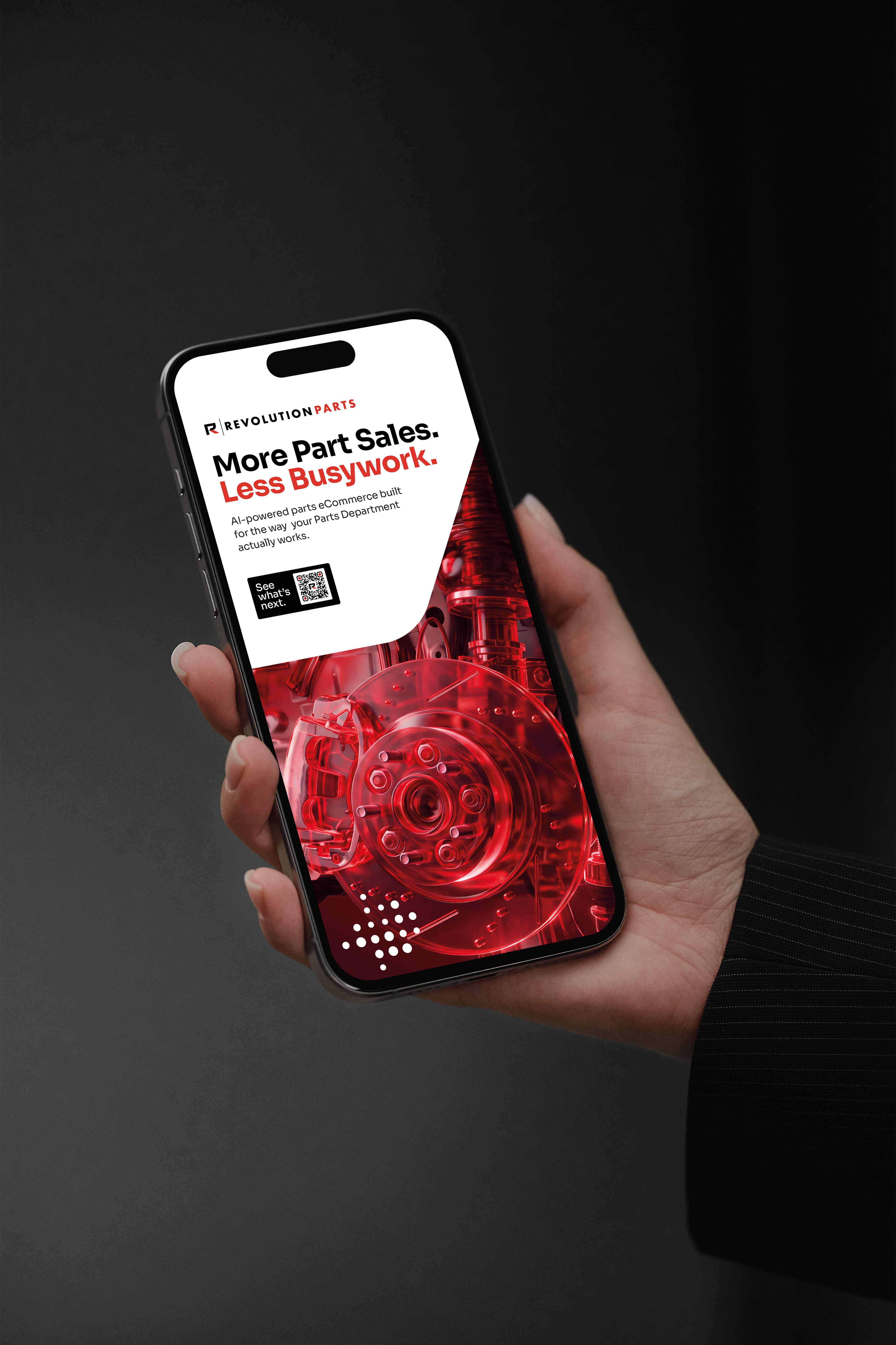 Hand holding a phone displaying the More Part Sales, Less Busywork campaign