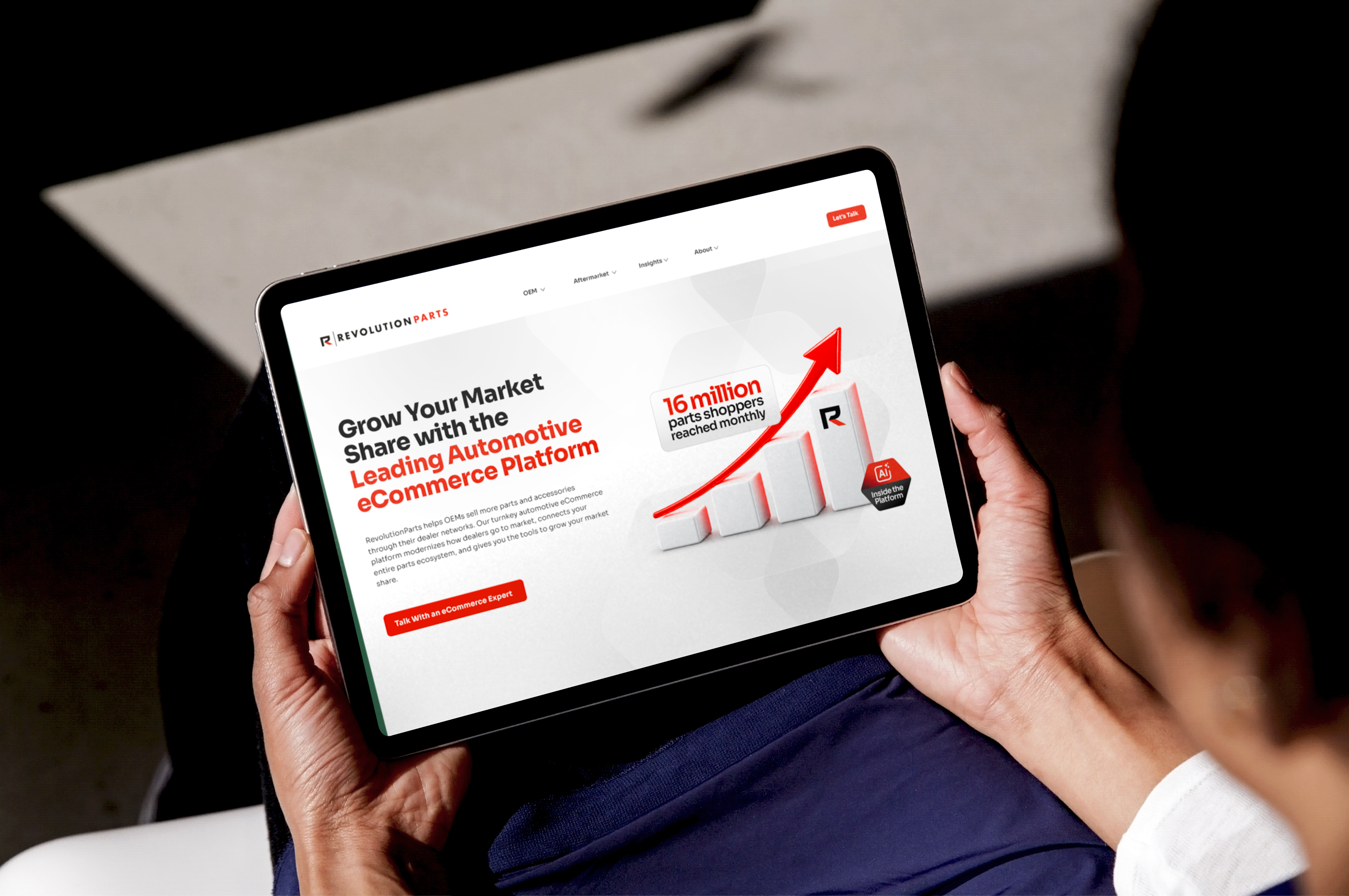 iPad displaying the RevolutionParts homepage with market share growth messaging